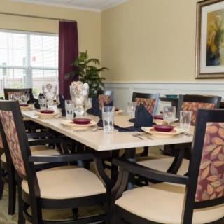 A well-decorated dining room with a large table set for a meal.