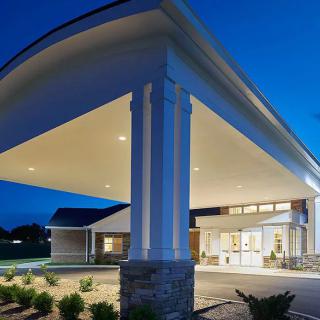 Modern building entrance illuminated at night.