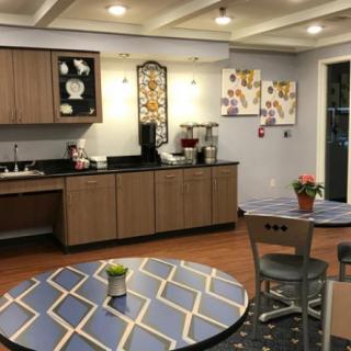 A modern kitchen and dining area with a coffee station and stylish decor.