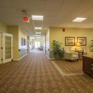 A well-lit hallway with comfortable seating and decorative elements.