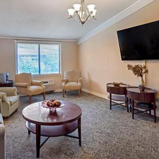 A cozy living room with comfortable seating, a large TV, and a coffee table.
