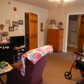 A cozy living room with furniture and a walker.