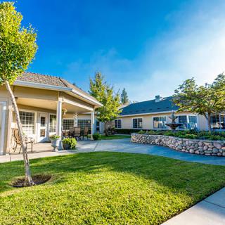 A beautiful residential setting with a well-maintained yard and sunny weather.