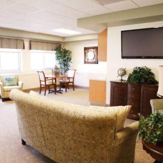 A cozy living room with comfortable seating and a mounted television.