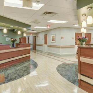 A modern hospital interior featuring a spacious hallway and reception area.