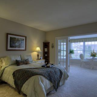 A cozy bedroom with elegant furnishings and ample natural light.