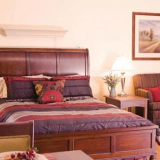 A cozy bedroom with a large, well-made bed and elegant decor.