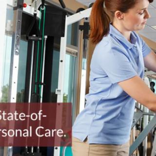 A healthcare professional assists a person with rehabilitation exercises in a modern facility.
