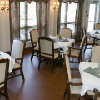 A neatly arranged dining room with tables set for guests.