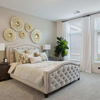 A cozy and elegantly designed bedroom with soft lighting and stylish decor.
