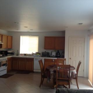 A cozy kitchen and dining area with wooden furniture and appliances.