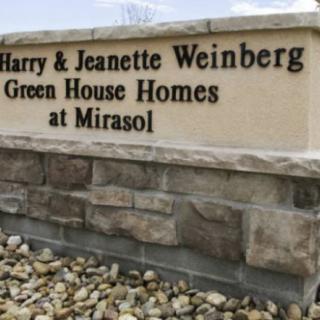Sign for the Harry & Jeanette Weinberg Green House Homes at Mirasol.