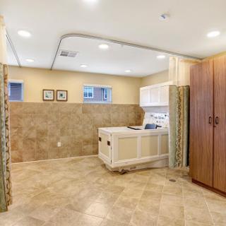 A modern kitchen featuring bright lighting, stylish cabinetry, and elegant tile flooring.