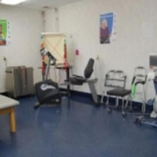 A small gym area with exercise equipment and seating.