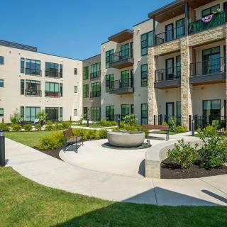 A modern apartment complex with a landscaped courtyard.