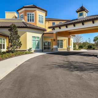 A modern residential building with a welcoming entrance and landscaped surroundings.