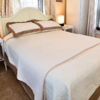 A neatly made bed in a cozy bedroom setting.