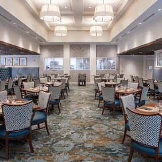 A spacious and elegantly designed restaurant interior featuring stylish seating and modern lighting.
