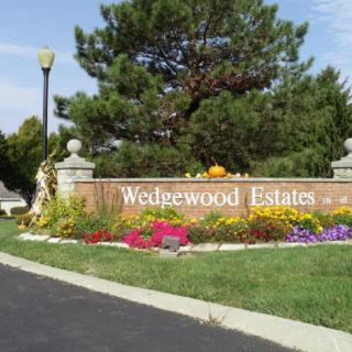 Entrance to Wedgewood Estates with landscaped flowers and greenery.