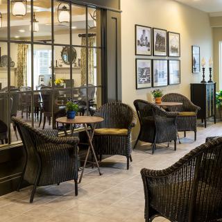 A cozy indoor seating area with wicker chairs and a warm, modern decor.