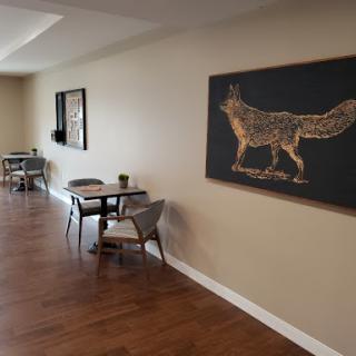 A cozy caf interior featuring a decorative fox artwork on the wall.