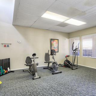 A small gym area equipped with exercise bikes and an elliptical machine.
