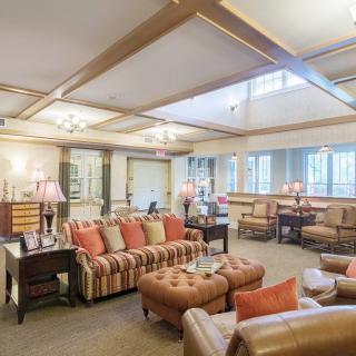 A spacious and cozy living room with comfortable seating and warm lighting.