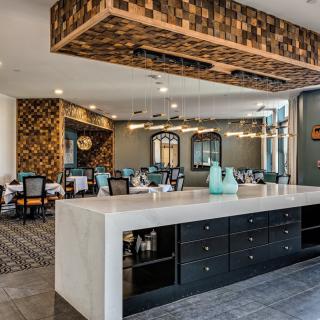 A stylish and modern kitchen and dining area with elegant lighting and sleek furniture.