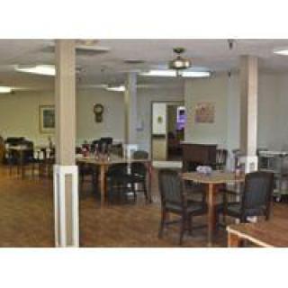 A spacious dining area with tables and chairs arranged neatly.