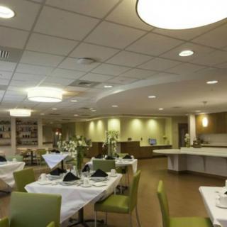 A modern restaurant dining area with neatly arranged tables and contemporary decor.