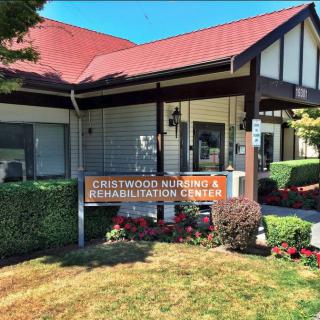 Exterior view of a nursing and rehabilitation center with well-maintained landscaping.
