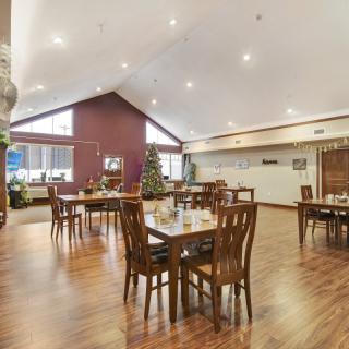 Spacious dining area with wooden floors and elegant seating arrangement.
