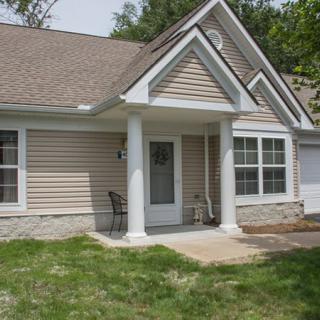 A suburban house with a porch and front yard.
