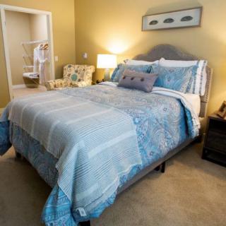 A cozy and modern bedroom with stylish bedding and warm lighting.
