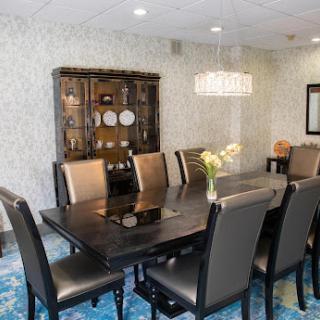 A stylish and modern dining room featuring elegant furniture and a chic chandelier.