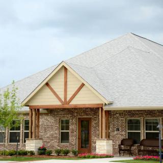 A suburban house with a brick exterior and a front porch.