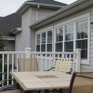 A cozy outdoor patio area featuring a table and chairs, perfect for relaxation.