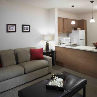 A cozy open floor plan featuring a modern living room and kitchen.