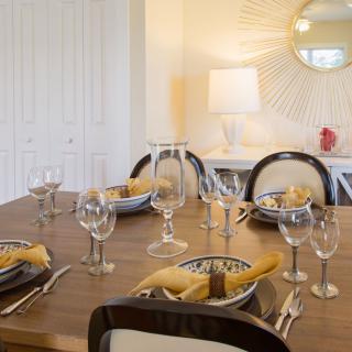An elegantly set dining table with stylish decor and ambient lighting.