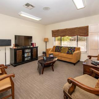 Cozy living room with a TV, sofa, and elegant furnishings.