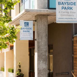 An outdoor view of the Bayside Park building with signage displayed.