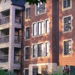 A multi-story brick residential building with several windows.