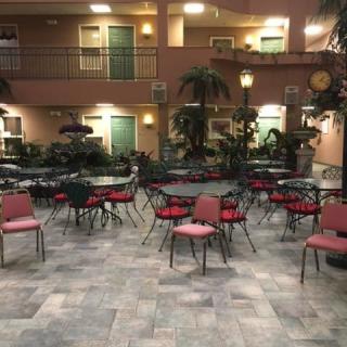 Indoor seating area with tables and chairs in a hotel lobby.