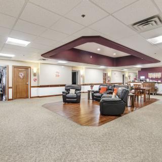 A spacious lobby area with seating arrangements and warm lighting.