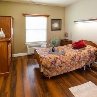 A cozy and well-decorated bedroom featuring wooden furniture and warm colors.