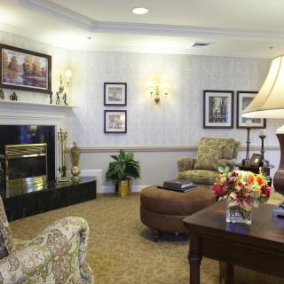 A cozy living room featuring a fireplace, comfortable seating, and tasteful decor.