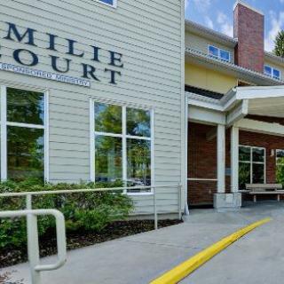 The exterior entrance of a residential building with a visible sign.