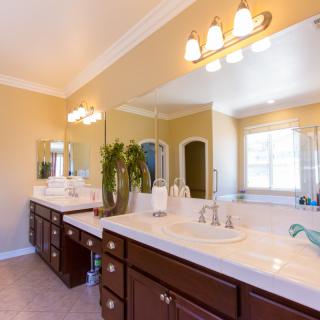 A spacious and well-lit bathroom with a double sink vanity.