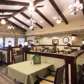 A cozy restaurant interior with elegant lighting and neatly arranged tables and chairs.