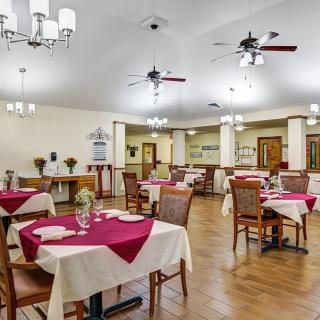 A well-decorated dining area with tables and chairs set for a meal.
